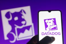 Purple Datadog logo of puppy holding a chart in its mouth on smartphone and in background