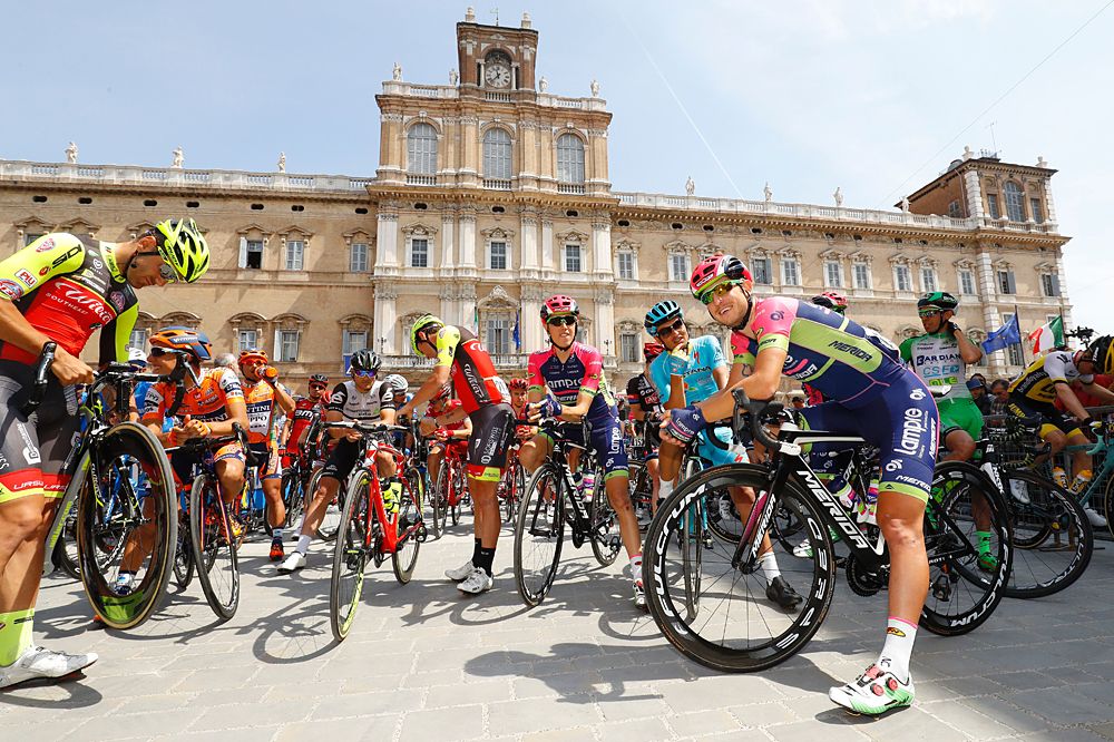 Riders wait in front of the military academy of Modena before the start of the 11th stage of the 99th Giro d'Italia