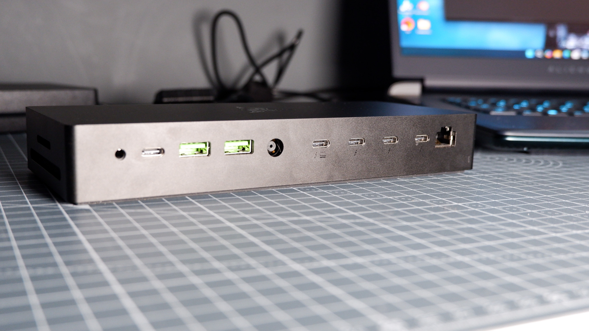 The Razer Thunderbolt 5 Dock on a desk with the RGB enabled and an SSD installed.