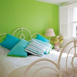 bedroom with green wall and white window