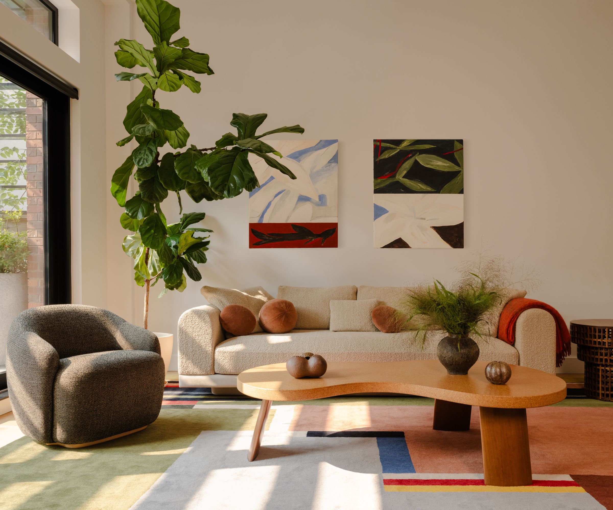 living room with bright rug and curved coffee table