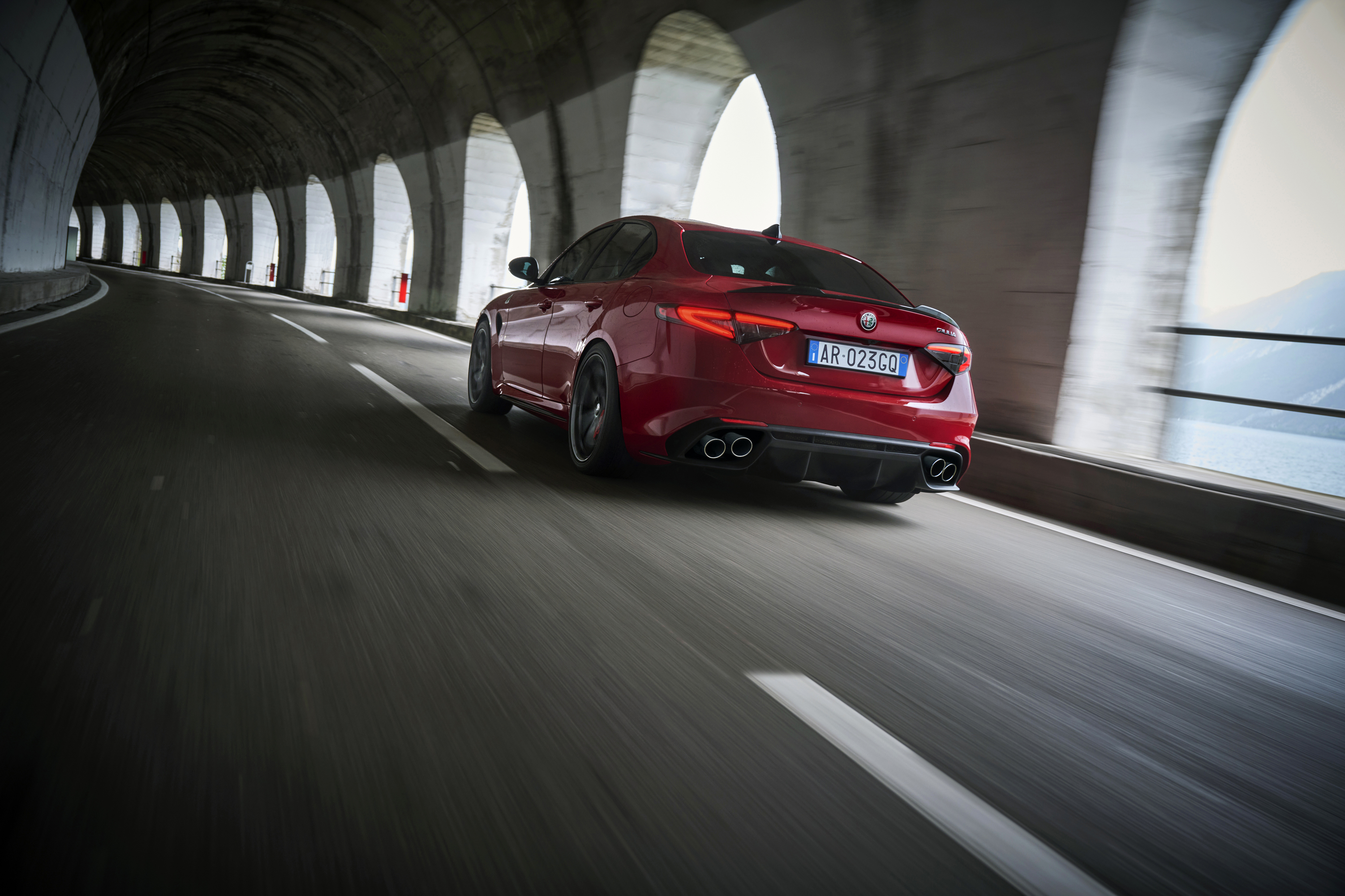 A red Alfa Romeo Giulia zooming about on an airfield