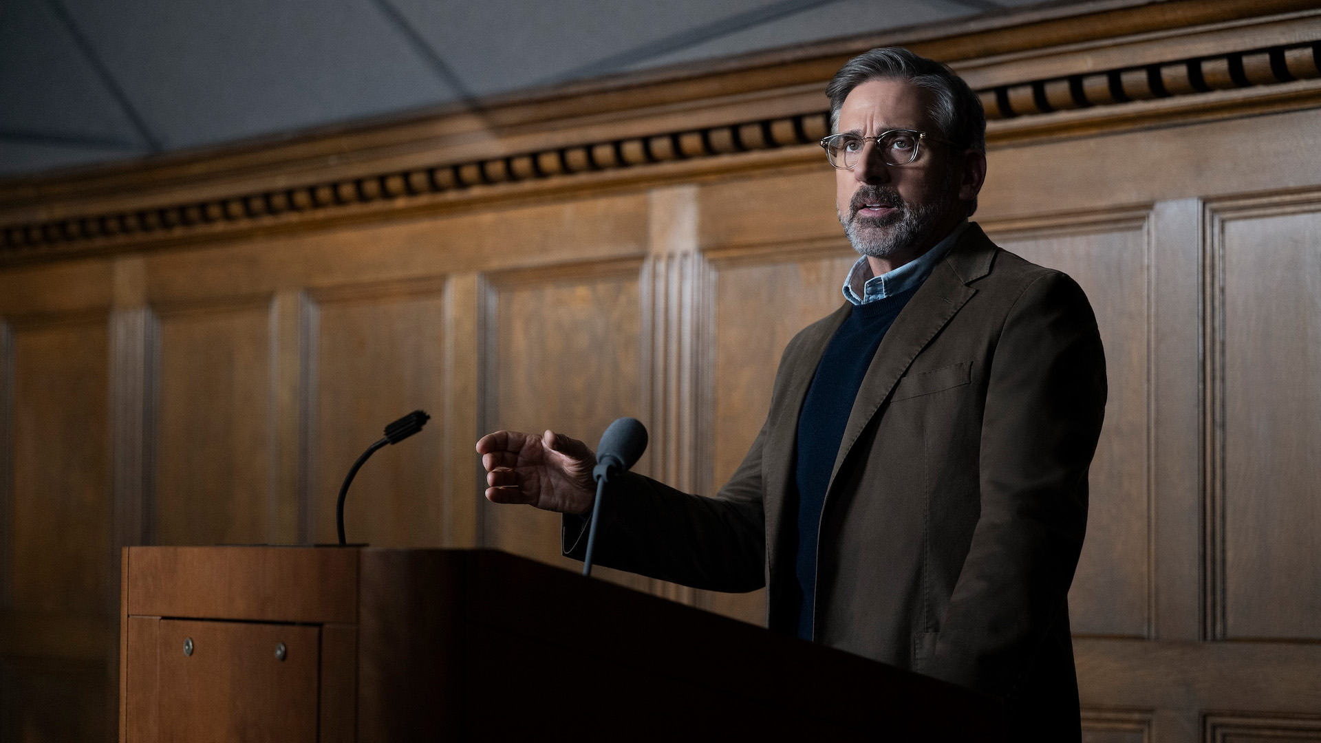 Steve Carell as Greg in Rooster, delivering a lecture.