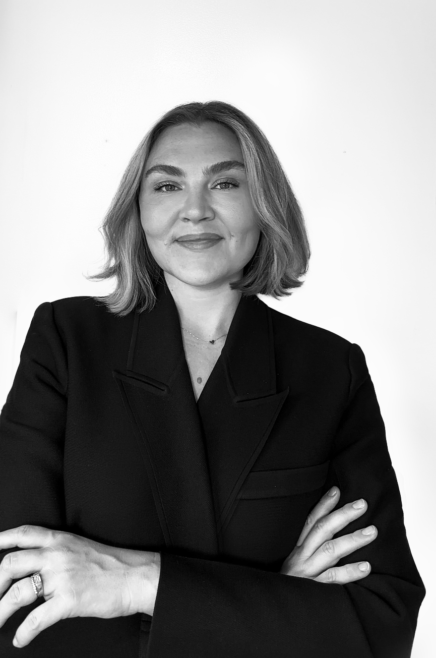 a black and white photo of a white woman in a black blazer