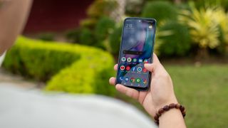 POCO M5s in hand showing the screen