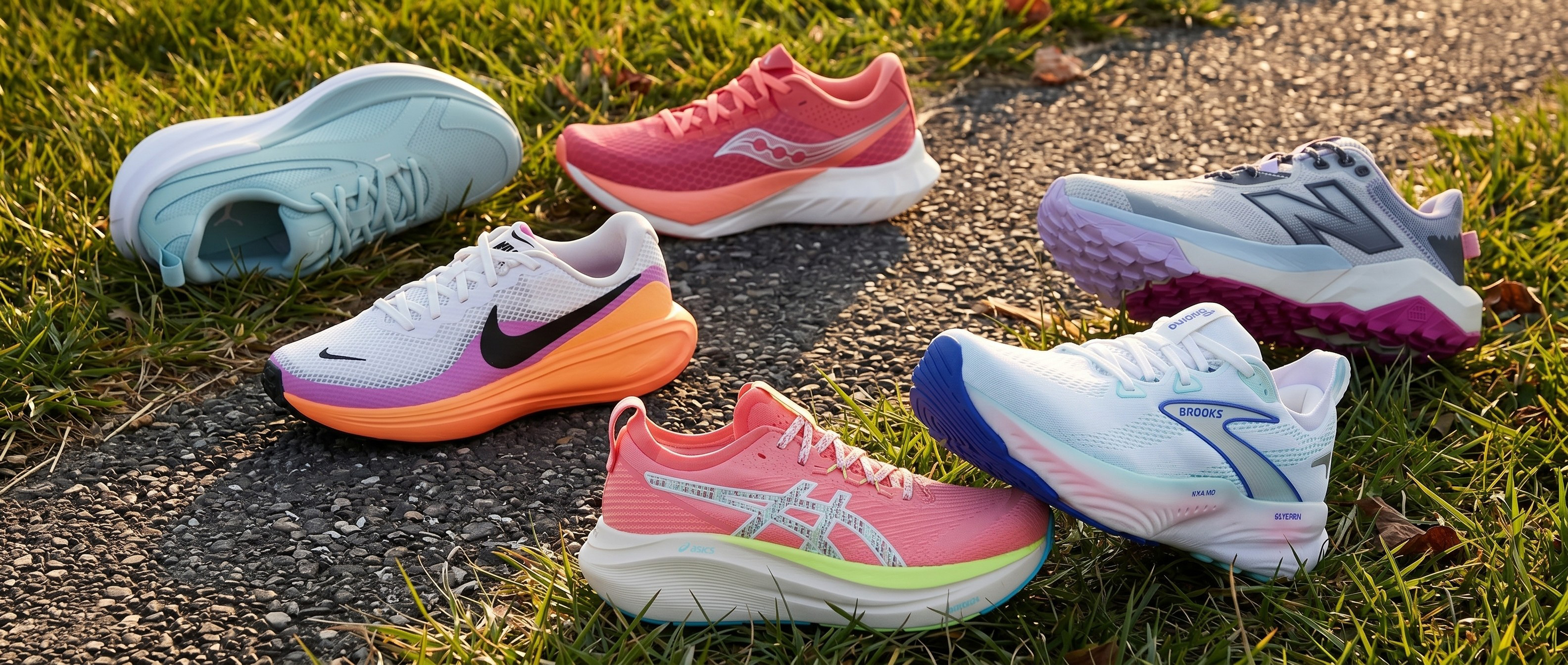 Selection of women's running shoes on a grass and tarmac backround