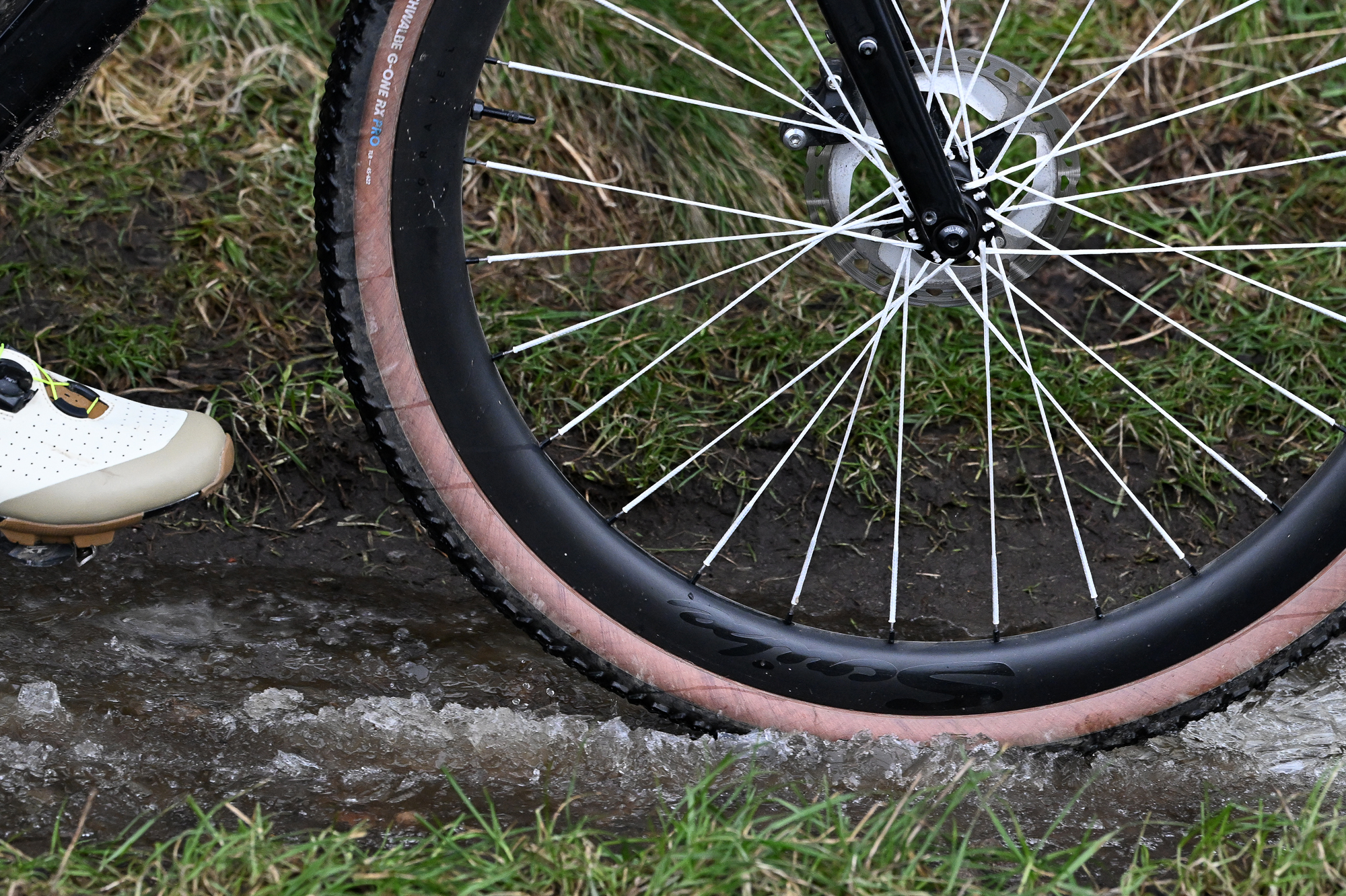 Close up of a G-One RX Pro Gravel tyre riding through a slushy puddle