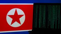 Laptop with green terminal code in front of DPRK flag