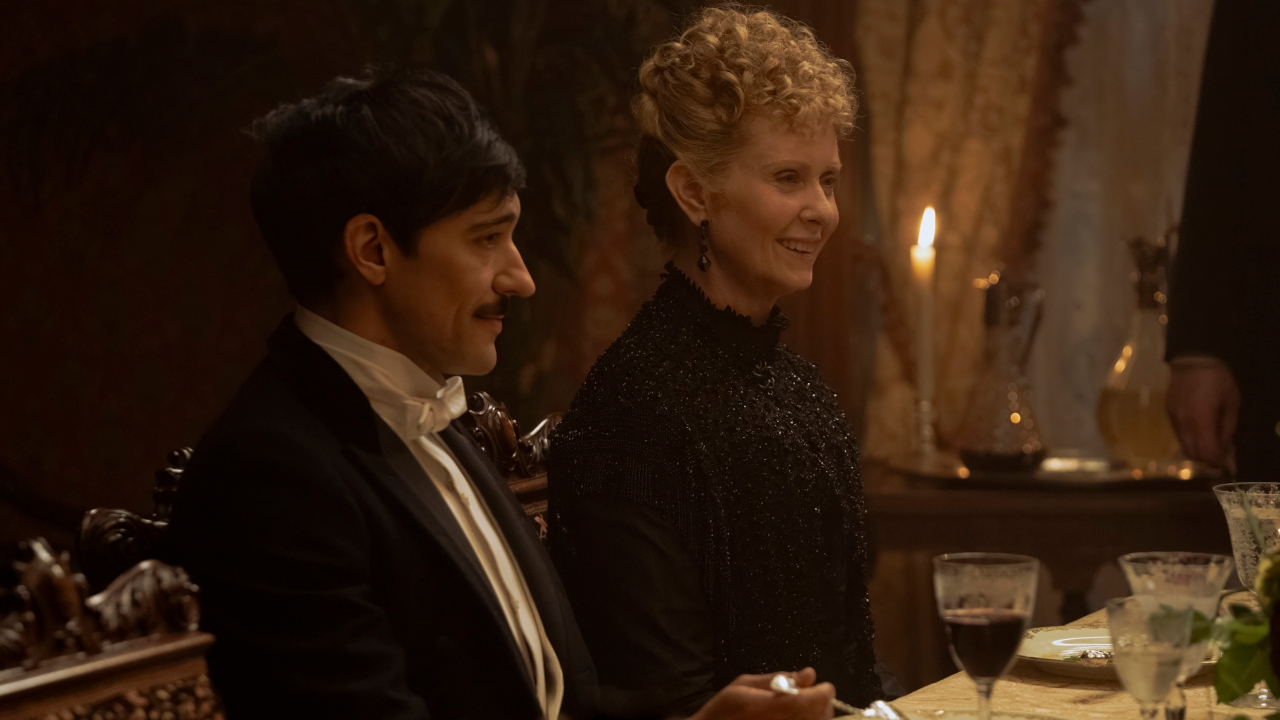 Blake Ritson and Cynthia Nixon sit together smiling at dinner in The Gilded Age S3 E1 - "Who Is In Charge Here?"