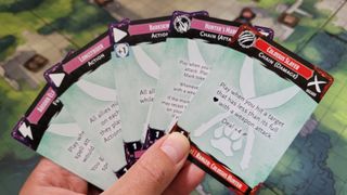 Cards from Dungeons & Dragons: Trials of Tempus held aloft