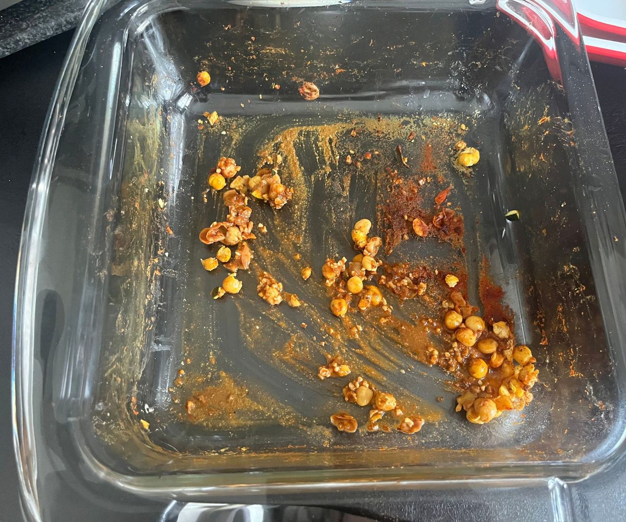 Spice mix and chickpeas in the base of a glass air fryer dish