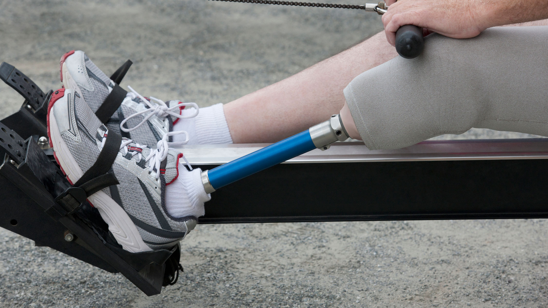 A man with a prosthetic leg exercising on a rowing machine