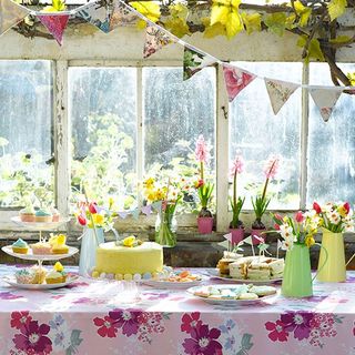 dining table with floral sheet and cakes