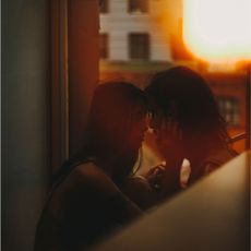 Caucasian woman caressing face of man - stock photo