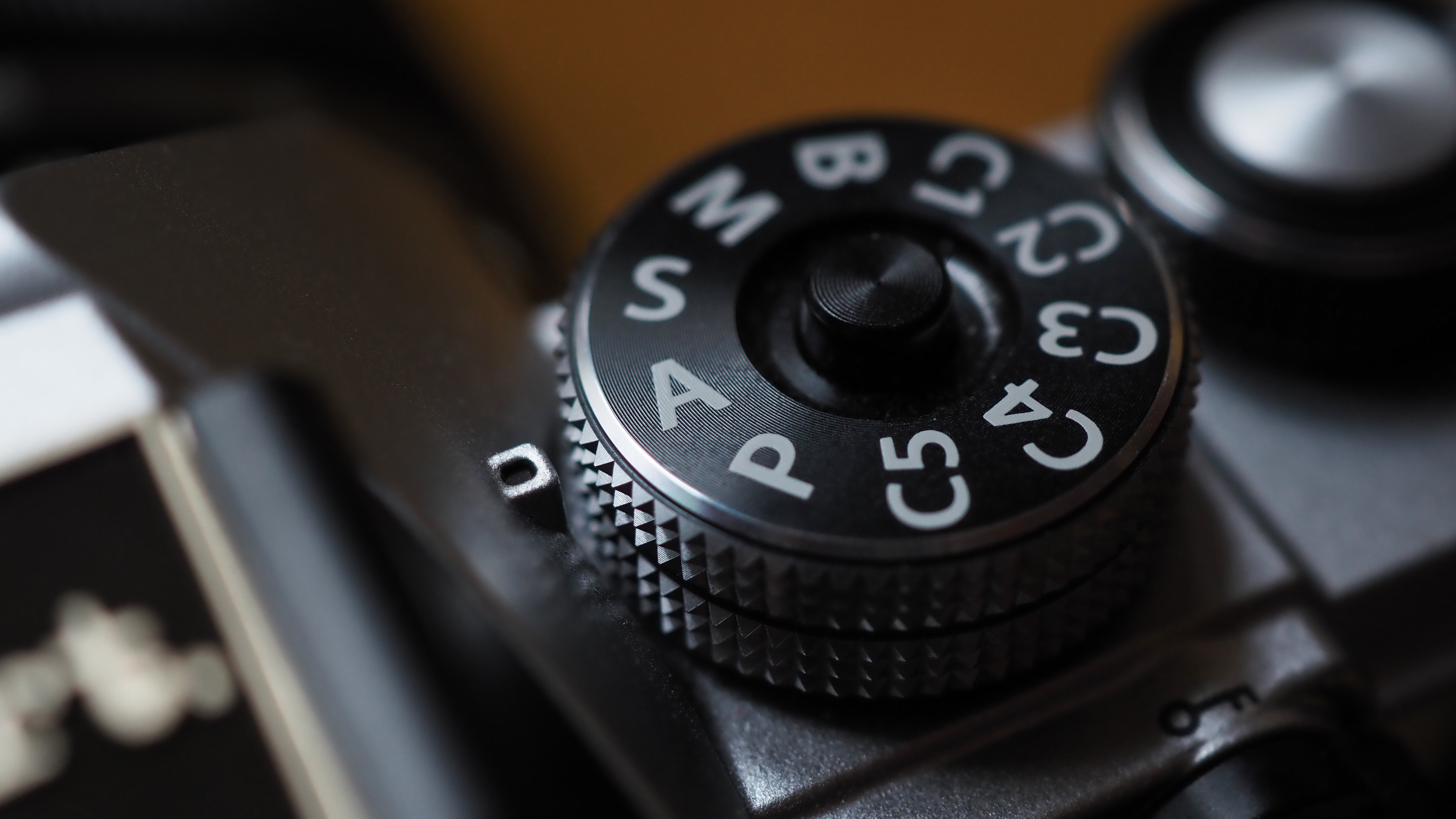 Close-up of the PASM dial with aperture priority mode selected