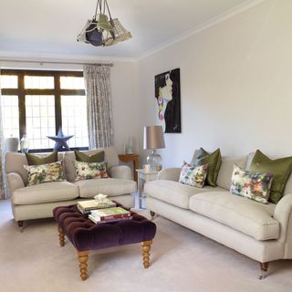 living room with cream wall and sofa set
