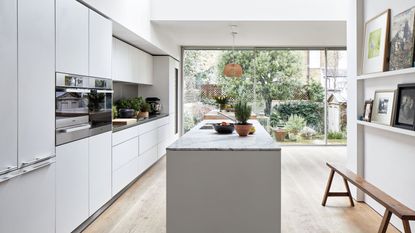 white kitchen with island and wooden floors