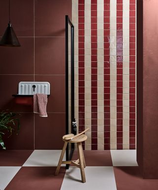 Red bathroom with striped tiles in the walk in shower