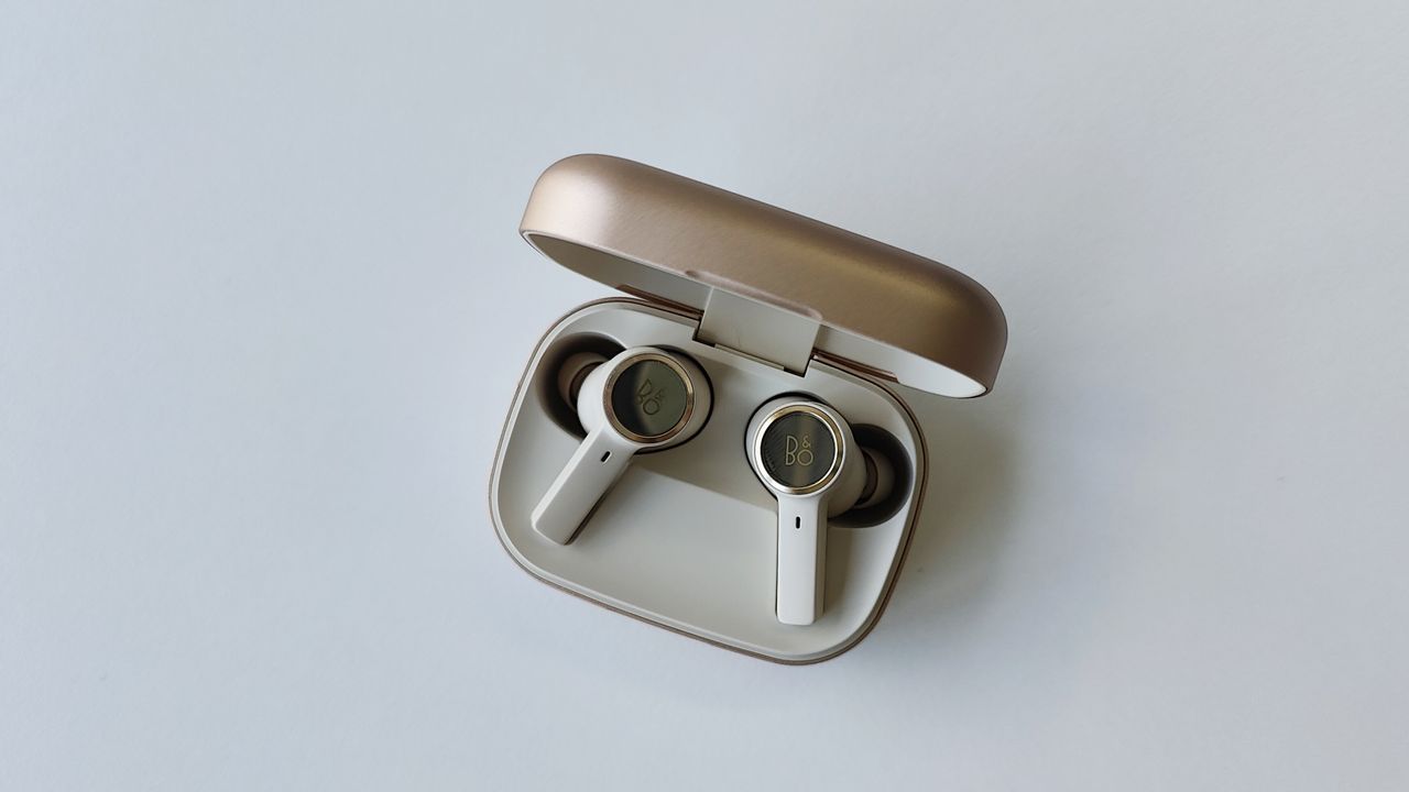 Bang &amp; Olufsen Beoplay EX review: earbuds in their matching case on a white table