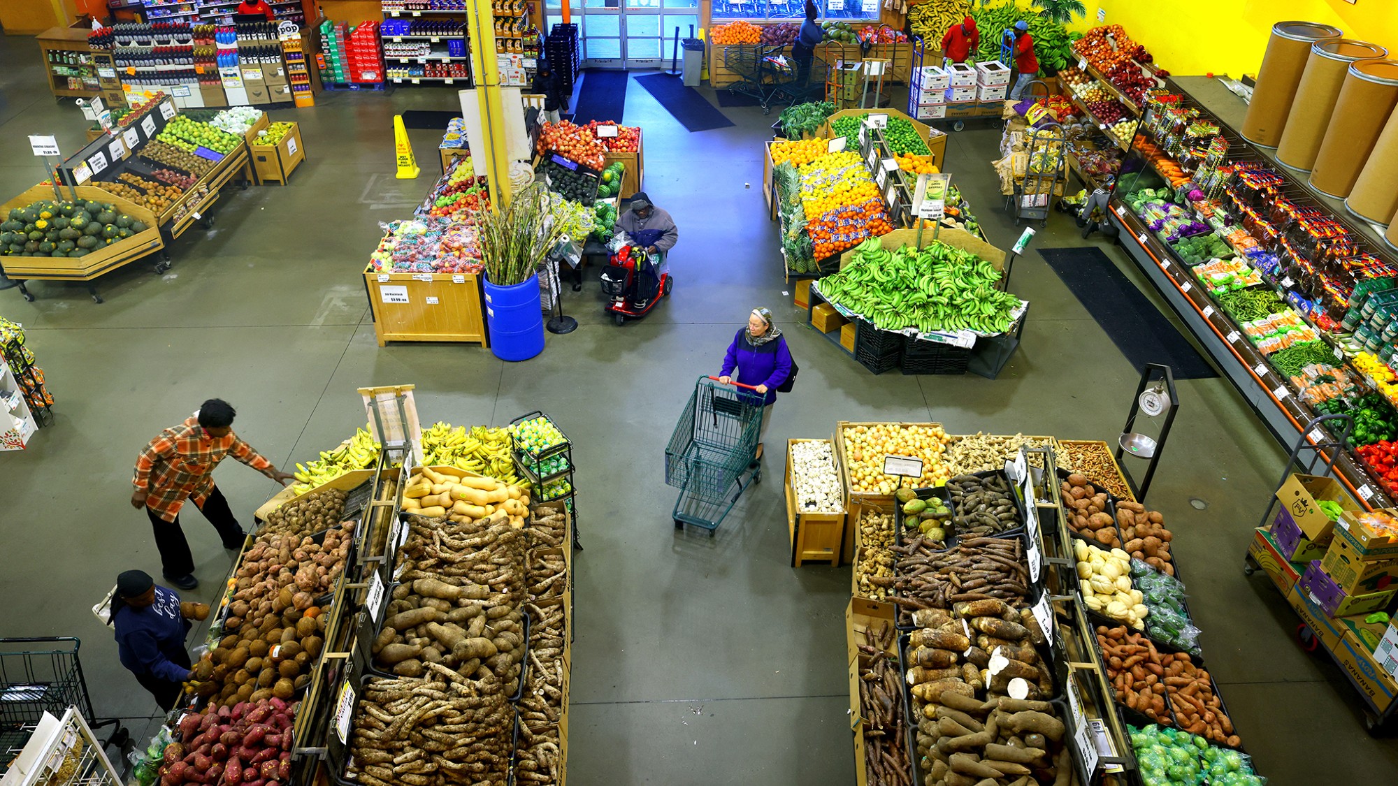 Customers shop the produce department at Tropical Foods grocery store in Boston, Massachusetts