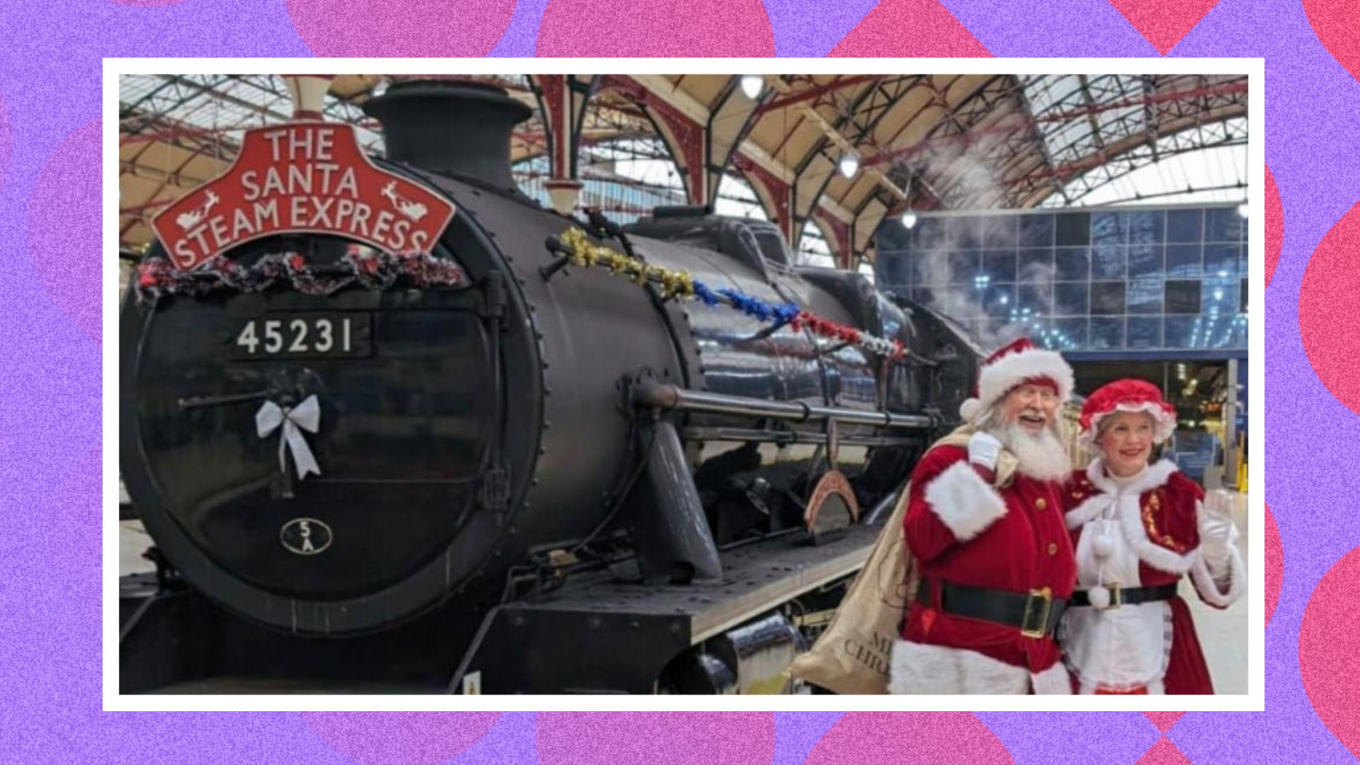Santa standing in front of a train