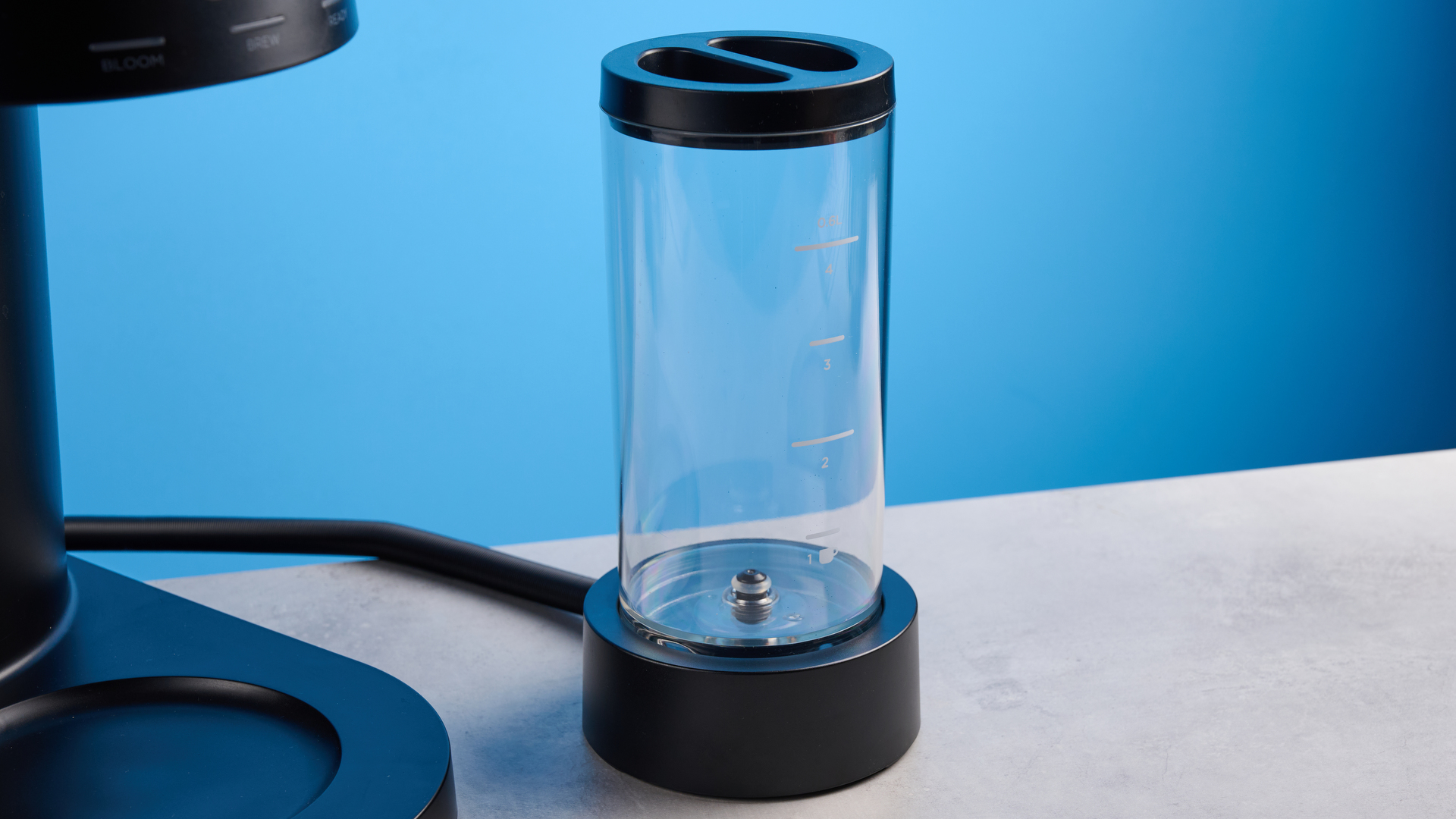 the ratio four coffee maker photographed against a blue tom's guide background