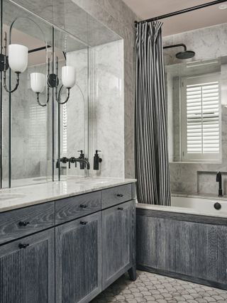 Grey bathroom with striped shower curtain