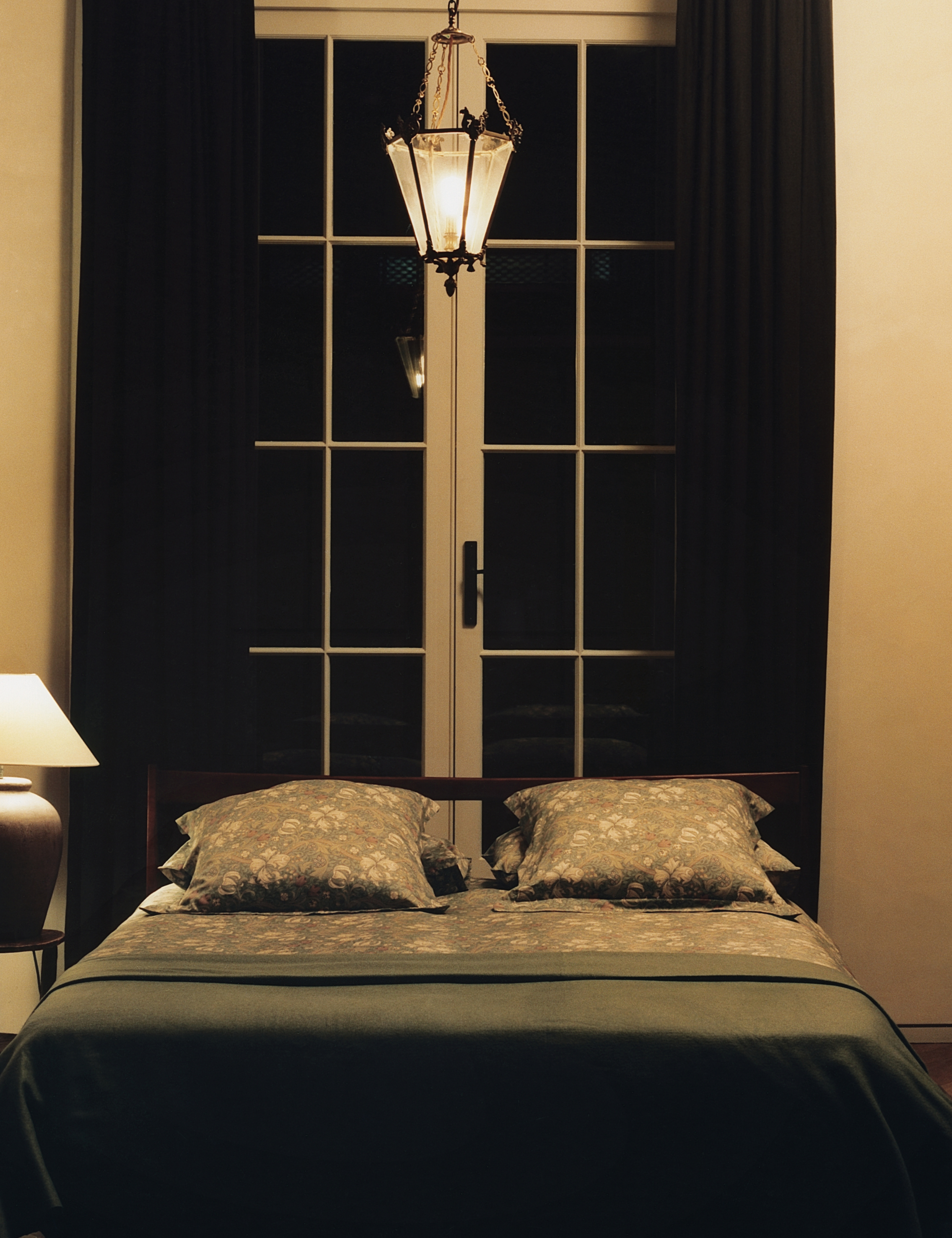 Modern London bedroom featuring a low-slung bed styled with muted floral sheets