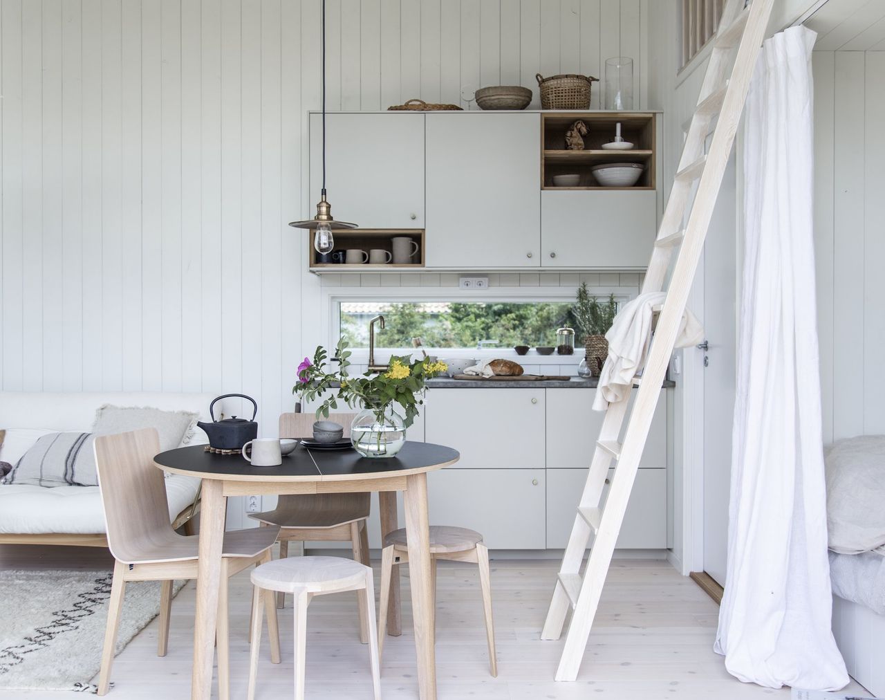 A small white cabin kitchen decorated in a Scandi-style