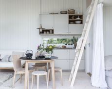 A small white cabin kitchen decorated in a Scandi-style