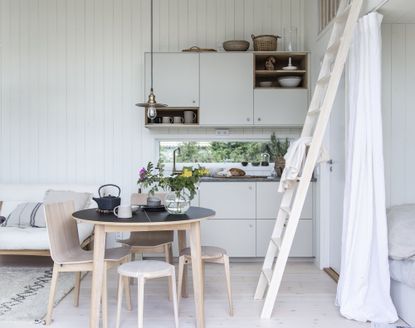 A small white cabin kitchen decorated in a Scandi-style