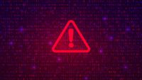 Ransomware concept image showing a warning symbol in red with binary code in background.