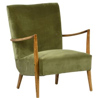 Low seated velvet green upholstered contemporary wooden armchair with naturally grained wooden legs