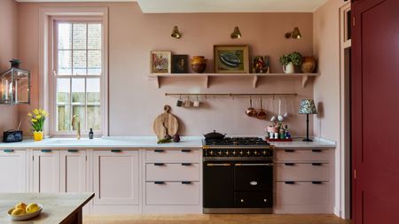 A light pink color drenched kitchens with burgundy accents