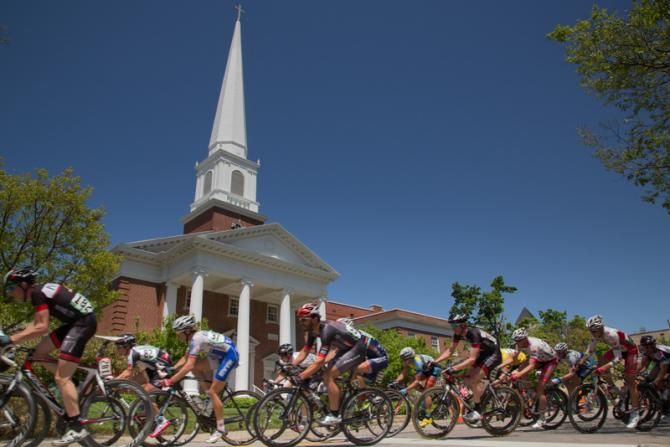 The men's peloton passes one of Fayetteville's churches during Sunday's criterium.