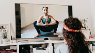 Woman following a yoga teacher online