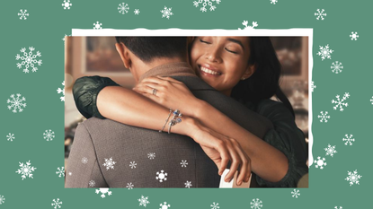 Image of a omwn hugging a man on a green snowflake backfround for Pandora Cyber Monday sale