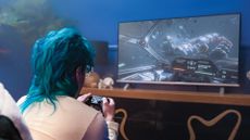 Woman playing Amazon Luna on a flatscreen TV