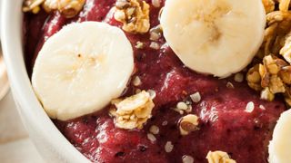 Berry smoothie bowl topped with granola and banana