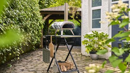 Ooni pizza oven on metal table.