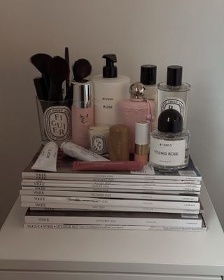 Photo of perfumes stacked on Vogue magazines