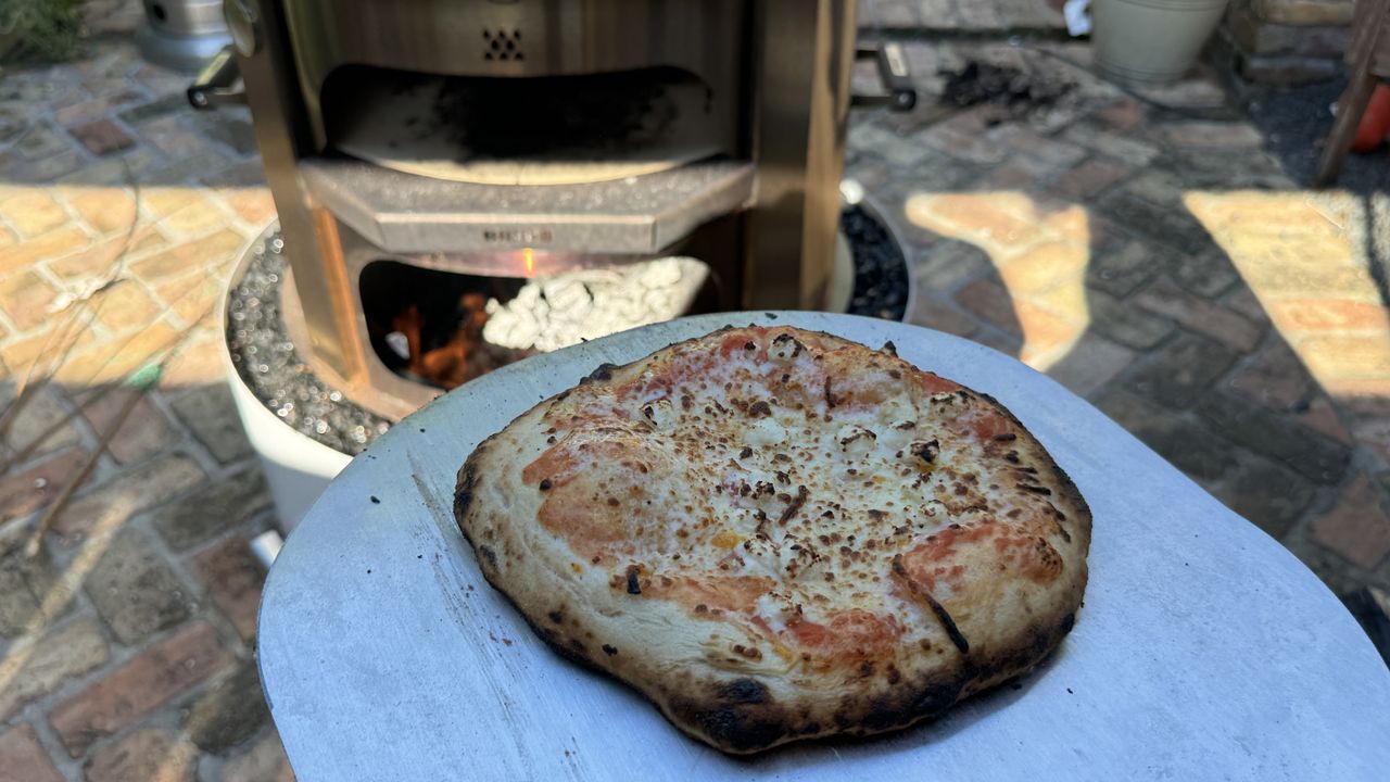 thin crust cheese pizza after being cooked in the Breeo Live Fire pizza oven