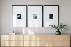 A corner in a home with three artworks