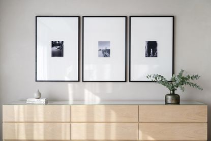 A corner in a home with three artworks