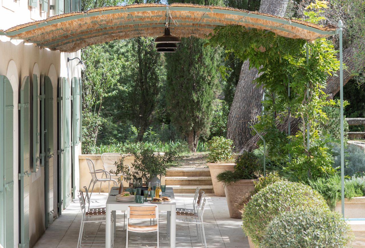 An outdoor space with a thachted roof