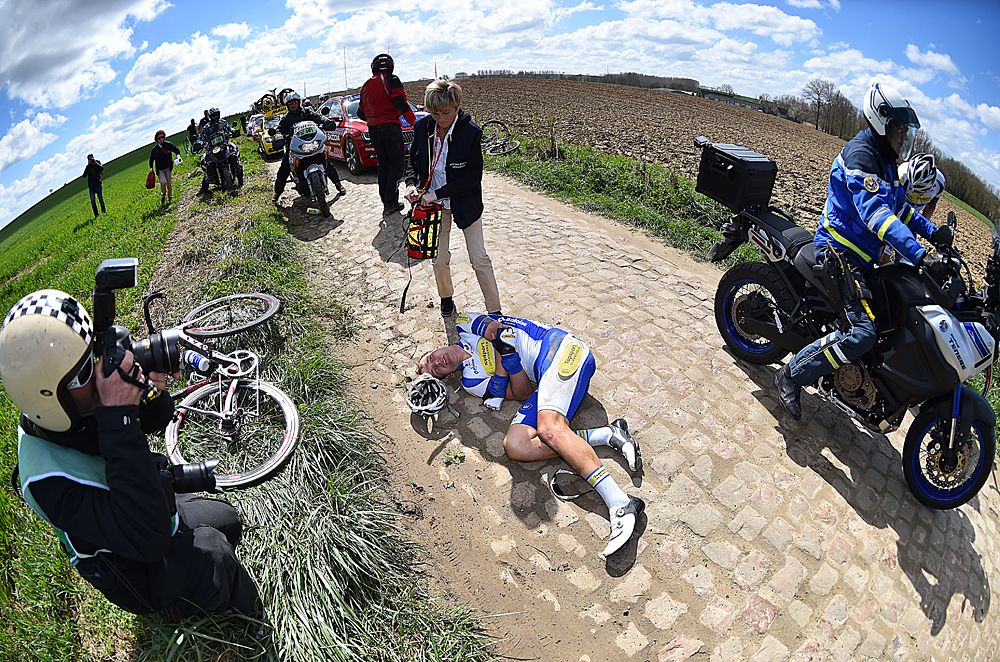 Jonas Rickaert clutches his elbow following a crash