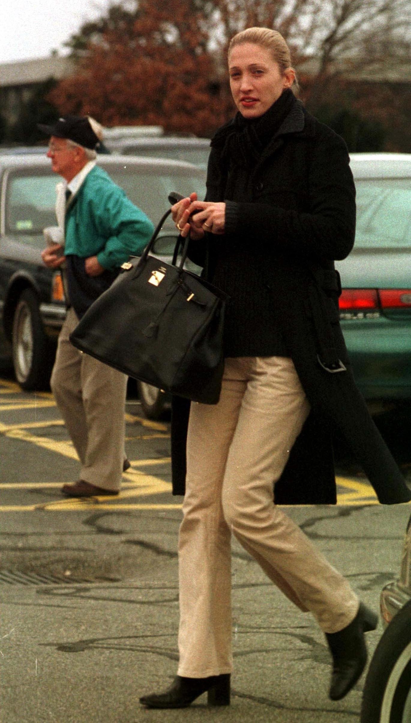 Carolyn bessette-kennedy wearing black coat and khaki pants