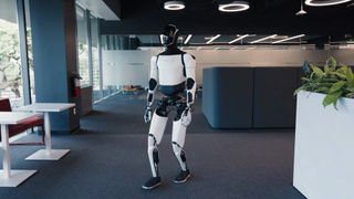 A Tesla promotional video showing the Optimus robot walking around an office