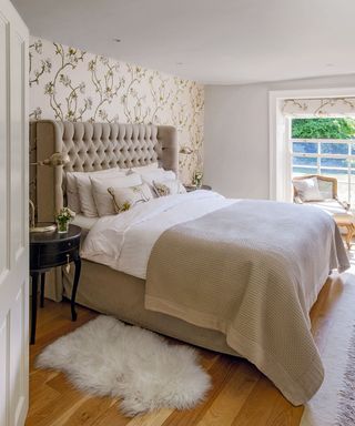 white bedroom with wallpaper and wooden flooring