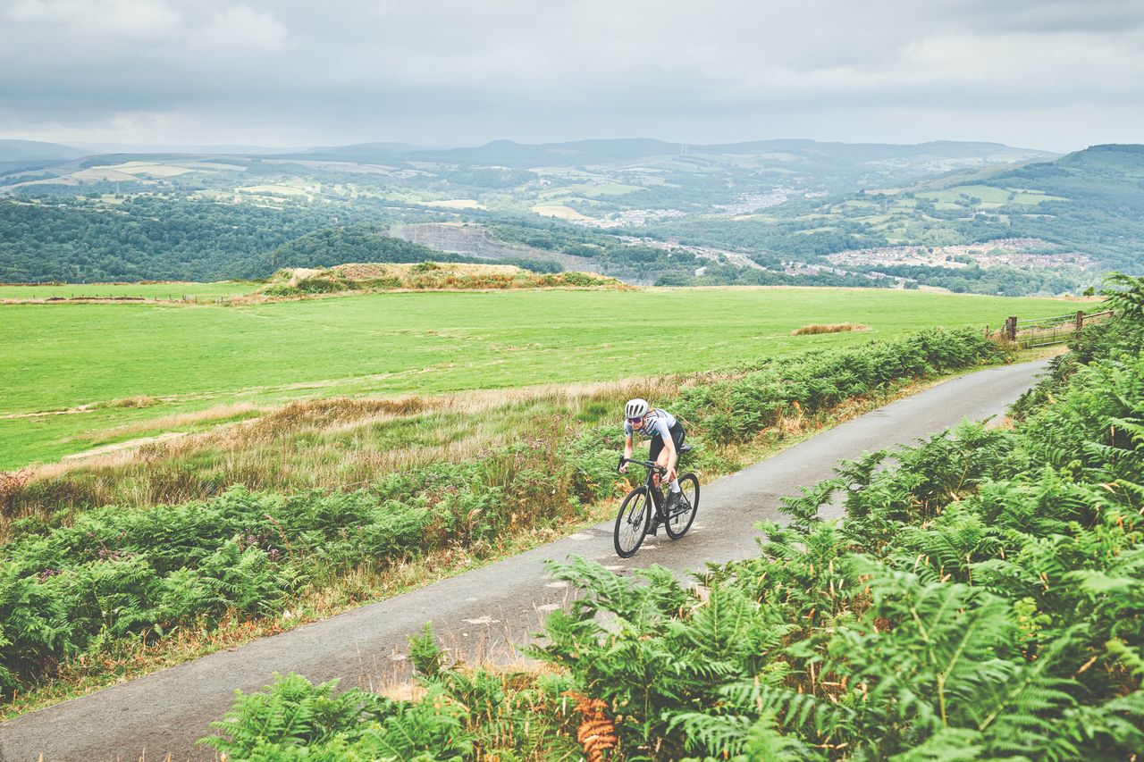 Female cyclist rides solo through countryside 